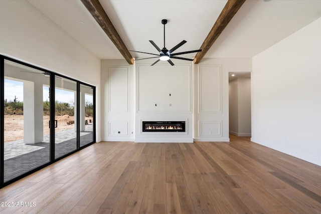 3323 N 81st St, Mesa, AZ 85207 - unfurnished living room featuring ceiling fan, light wood-style flooring, beam ceiling, a large fireplace, and baseboards