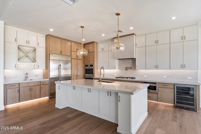 3323 N 81st St, Mesa, AZ 85207 - kitchen with beverage cooler, appliances with stainless steel finishes, a sink, decorative backsplash, and recessed lighting