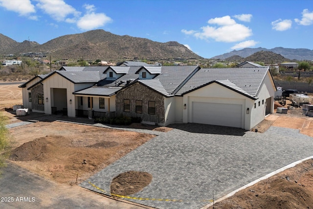 3323 N 81st St, Mesa, AZ 85207 - view of front of house with a garage, a mountain view, decorative driveway, stucco siding, and a tile roof