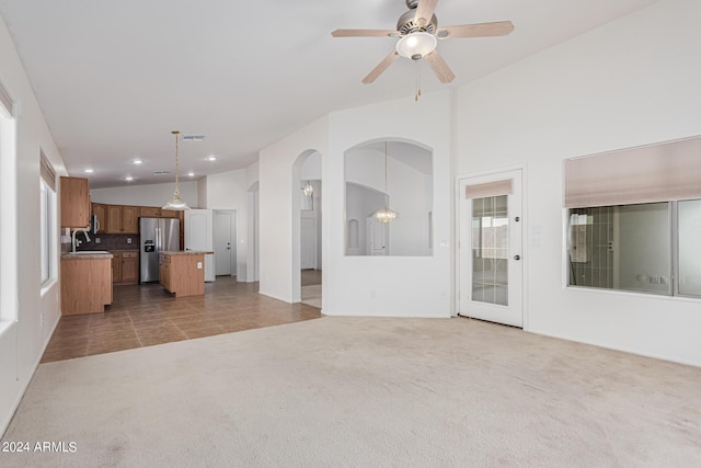 2268 S 162nd Ln, Goodyear, AZ 85338 - unfurnished living room with a sink, carpet flooring, a ceiling fan, arched walkways, and lofted ceiling