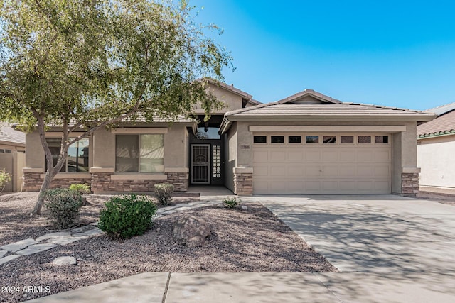 2268 S 162nd Ln, Goodyear, AZ 85338 - single story home featuring a tile roof, a garage, stone siding, concrete driveway, and stucco siding