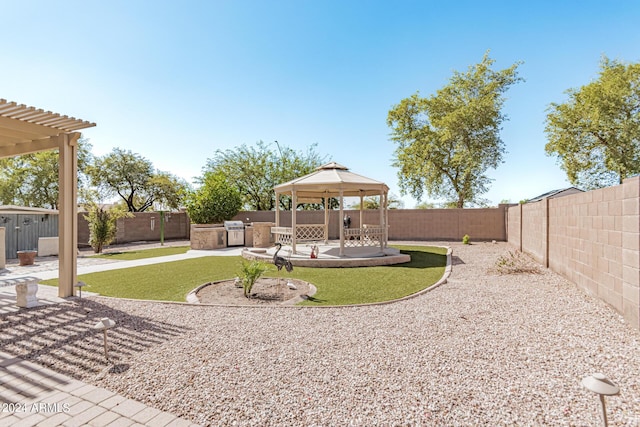 2268 S 162nd Ln, Goodyear, AZ 85338 - view of yard with a patio, exterior kitchen, a gazebo, and a fenced backyard