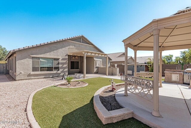 2268 S 162nd Ln, Goodyear, AZ 85338 - back of property featuring a patio, a pergola, a fenced backyard, a lawn, and stucco siding