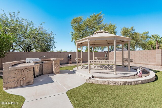 2268 S 162nd Ln, Goodyear, AZ 85338 - view of patio featuring a gazebo, a fenced backyard, area for grilling, and exterior kitchen
