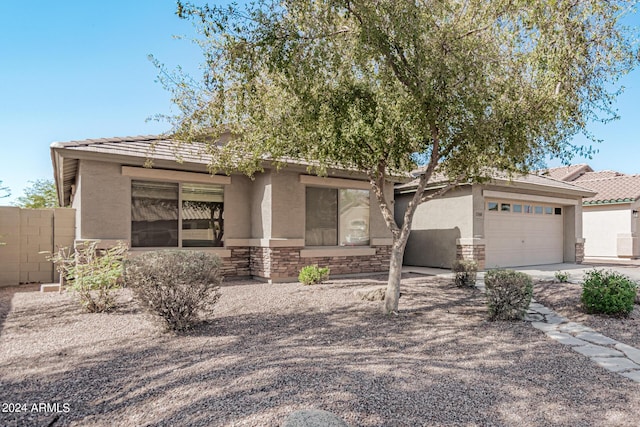 2268 S 162nd Ln, Goodyear, AZ 85338 - view of front of property featuring driveway, fence, a tiled roof, an attached garage, and stucco siding