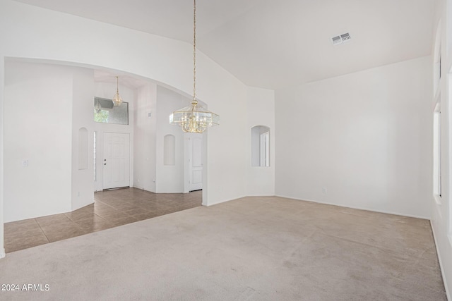 2268 S 162nd Ln, Goodyear, AZ 85338 - carpeted empty room with visible vents, arched walkways, an inviting chandelier, and high vaulted ceiling