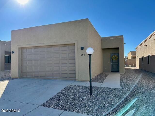 pueblo-style house featuring a garage