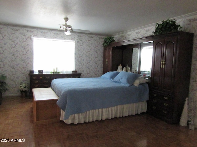 bedroom with multiple windows, dark parquet flooring, and ceiling fan