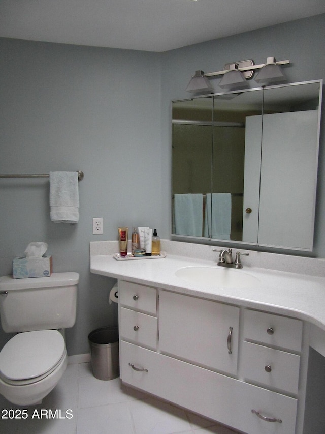 bathroom with vanity, toilet, and tile patterned flooring