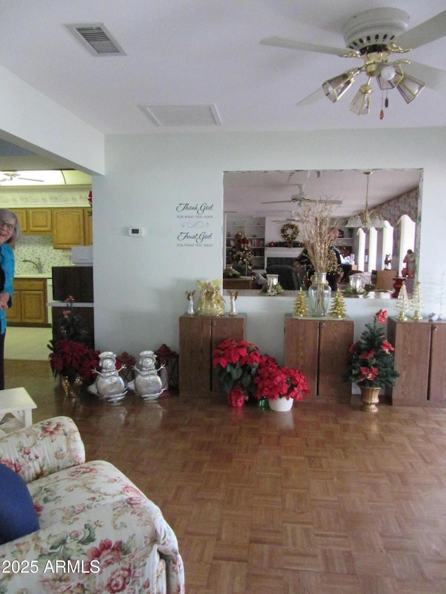 living room with parquet floors and ceiling fan