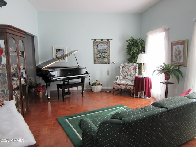 sitting room featuring dark parquet flooring