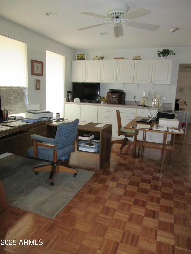 kitchen featuring white cabinetry, ceiling fan, dark parquet flooring, and decorative backsplash