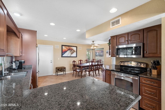 kitchen with light tile patterned floors, recessed lighting, stainless steel appliances, a sink, and visible vents