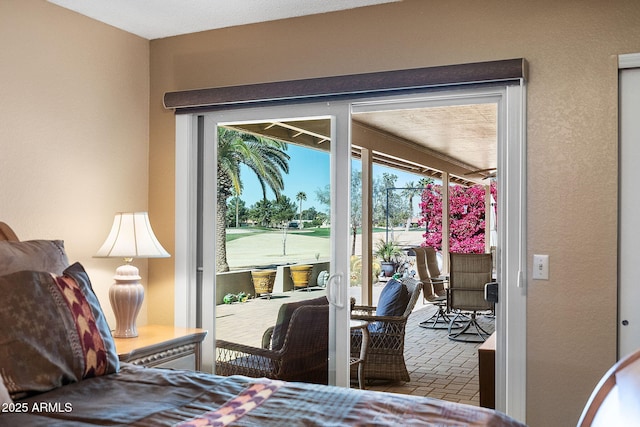 bedroom featuring access to outside and brick floor