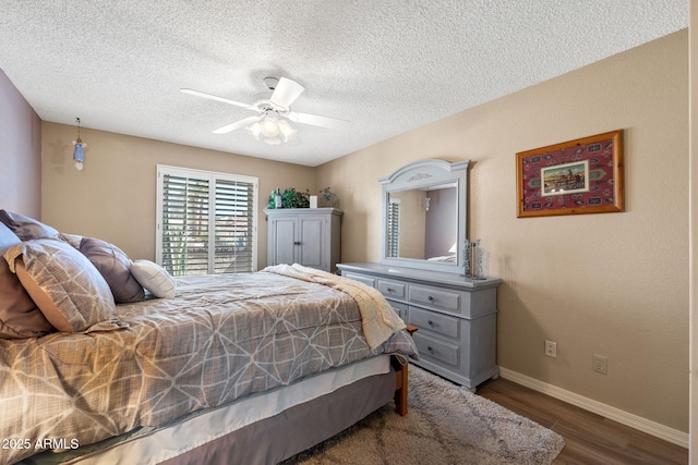 bedroom with dark wood-style flooring, ceiling fan, a textured ceiling, and baseboards