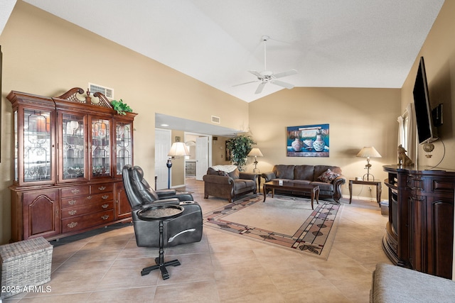 living area featuring light tile patterned floors, baseboards, visible vents, a ceiling fan, and high vaulted ceiling