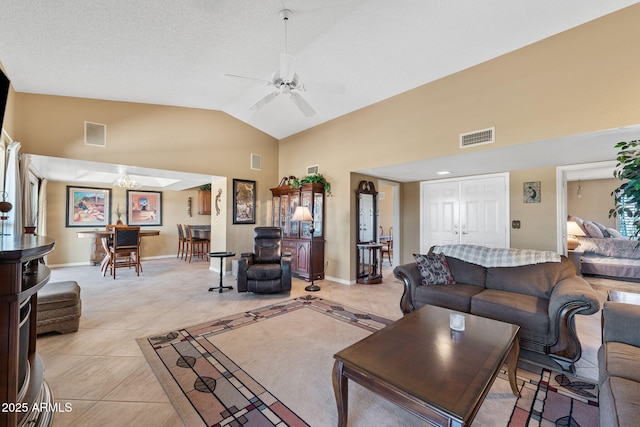 living room with visible vents, ceiling fan, and light tile patterned floors