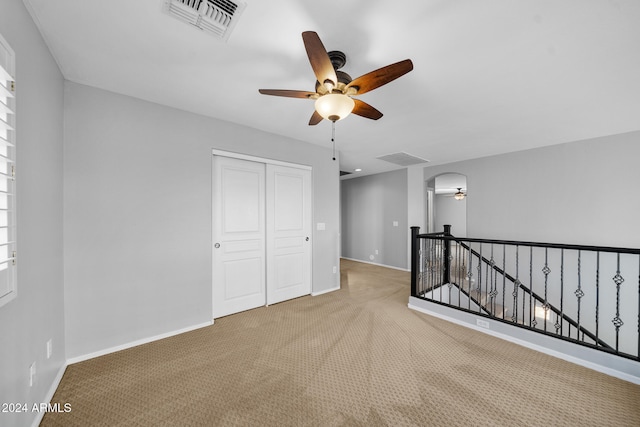 carpeted empty room with ceiling fan