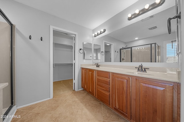 bathroom featuring tile patterned floors, vanity, and an enclosed shower