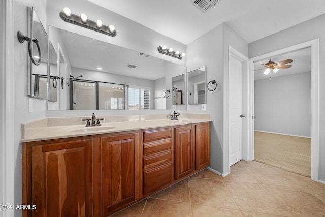 bathroom with ceiling fan, tile patterned flooring, vanity, and a shower with shower door