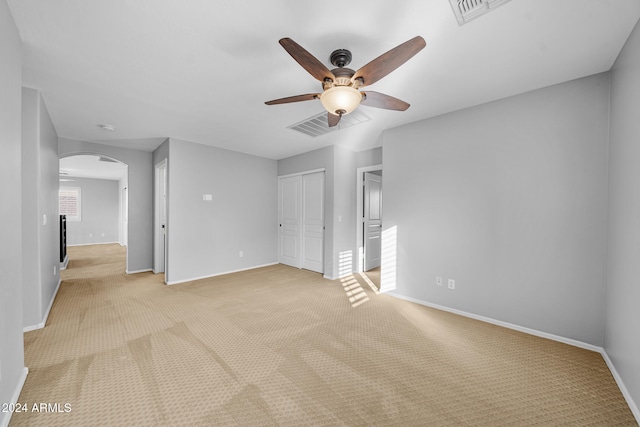 carpeted spare room with ceiling fan