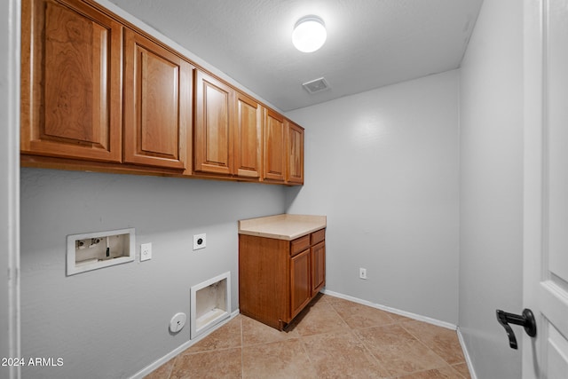 laundry area with cabinets, hookup for a washing machine, gas dryer hookup, electric dryer hookup, and light tile patterned flooring