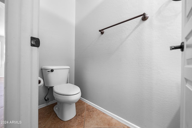 bathroom featuring tile patterned flooring and toilet