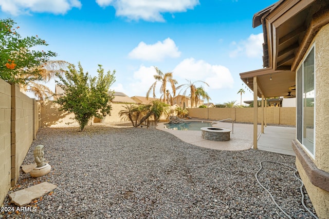 view of yard featuring a fire pit and a patio area