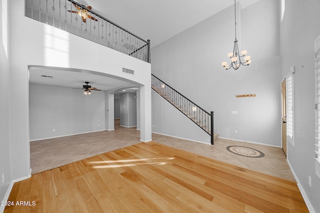 foyer featuring ceiling fan, basketball court, a high ceiling, and hardwood / wood-style flooring