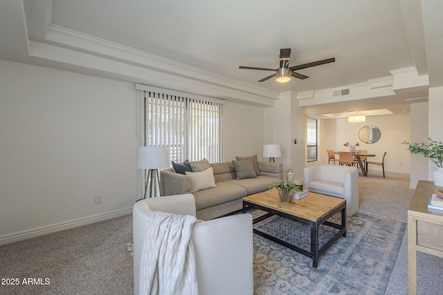 living room with baseboards, visible vents, crown molding, and carpet flooring