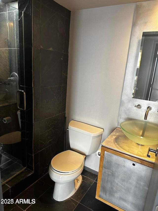 full bath with vanity, a shower stall, toilet, and tile patterned floors