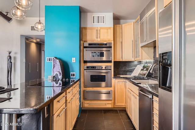 207 W Clarendon Ave Unit G18, Phoenix, AZ 85013 - kitchen with a warming drawer, stainless steel appliances, light brown cabinetry, a sink, and tasteful backsplash