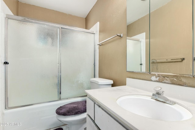 bathroom with toilet, shower / bath combination with glass door, and vanity