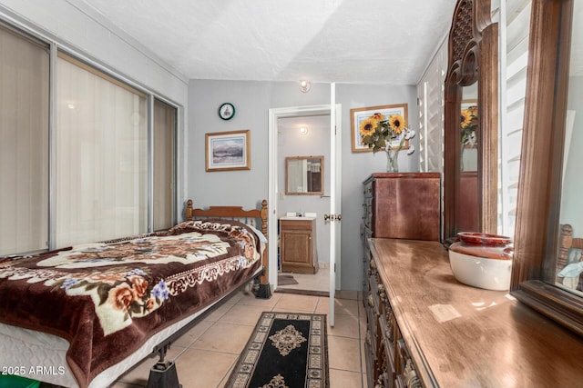 bedroom with light tile patterned floors, lofted ceiling, a textured ceiling, ensuite bathroom, and a closet