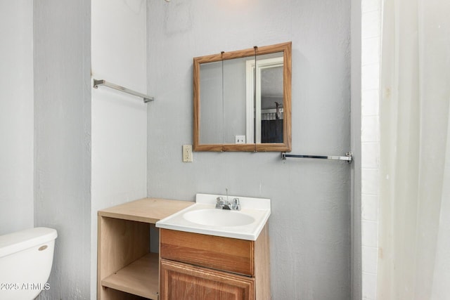 bathroom with toilet and vanity