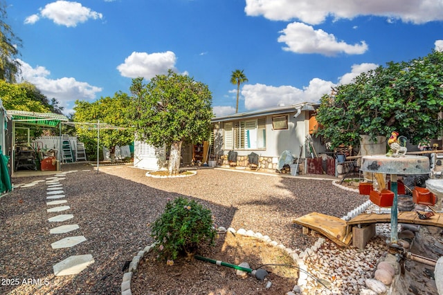 rear view of house with a patio, fence, an outdoor structure, and a storage shed