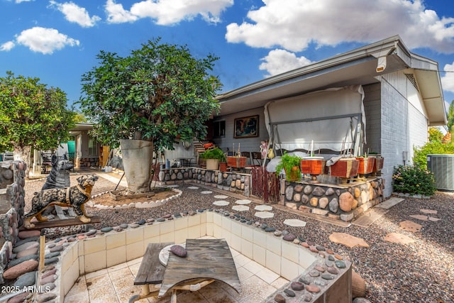 view of patio featuring cooling unit and exterior bar