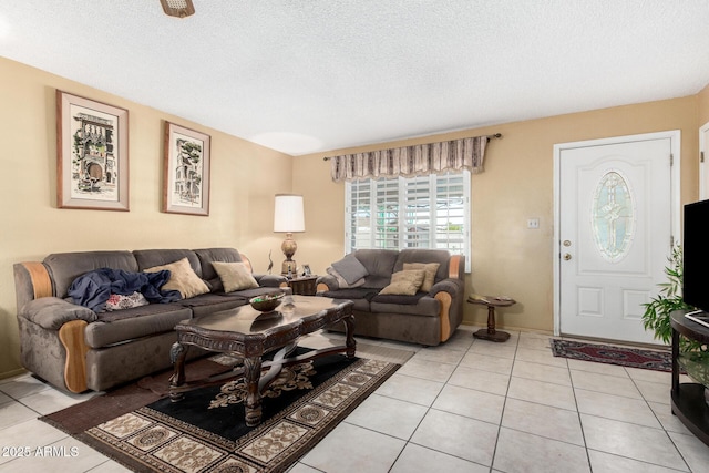 living area featuring a textured ceiling and light tile patterned flooring