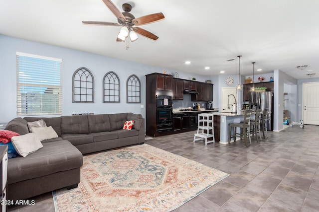 living room with sink and ceiling fan