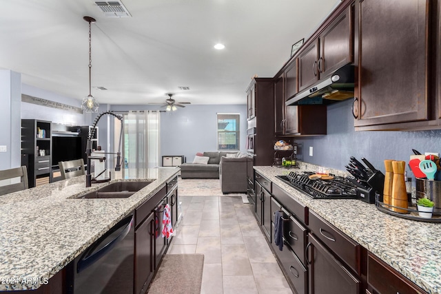 kitchen featuring black gas cooktop, decorative light fixtures, an island with sink, sink, and dishwashing machine