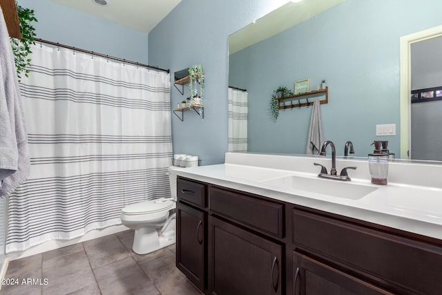 bathroom with tile patterned flooring, vanity, and toilet