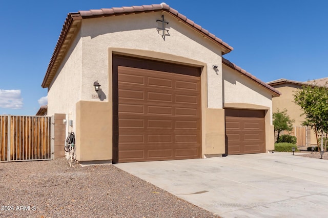 view of front of property with a garage and an outdoor structure