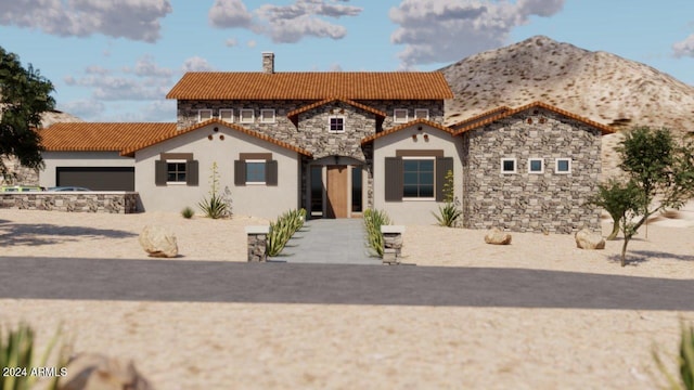 mediterranean / spanish home featuring a mountain view and a garage