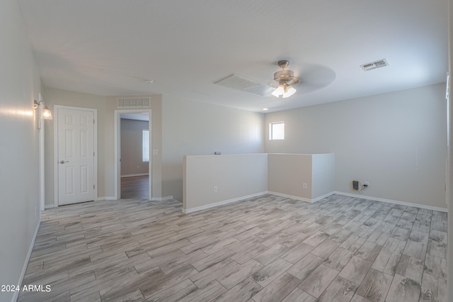 unfurnished room featuring ceiling fan and light wood-type flooring