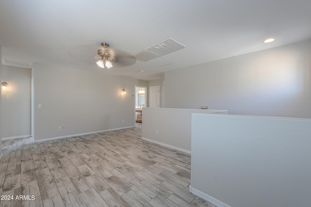 spare room featuring light wood-type flooring and ceiling fan