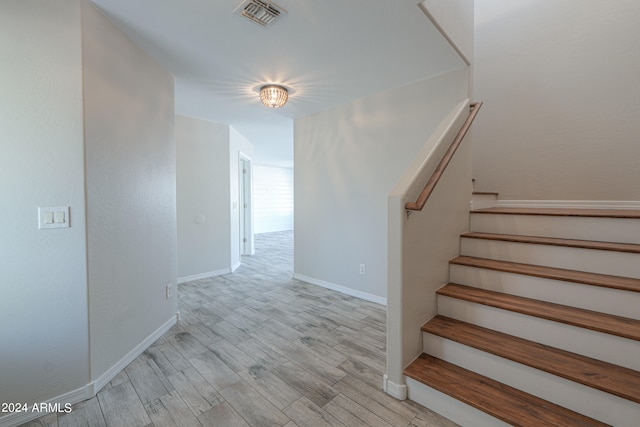 staircase featuring wood-type flooring