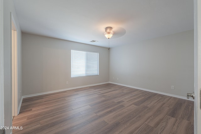 spare room with dark wood-type flooring