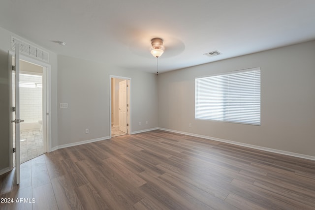 unfurnished room with ceiling fan and dark hardwood / wood-style floors