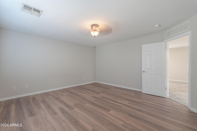 empty room featuring ceiling fan and hardwood / wood-style flooring