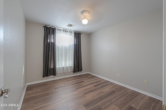 empty room featuring ceiling fan and dark hardwood / wood-style floors